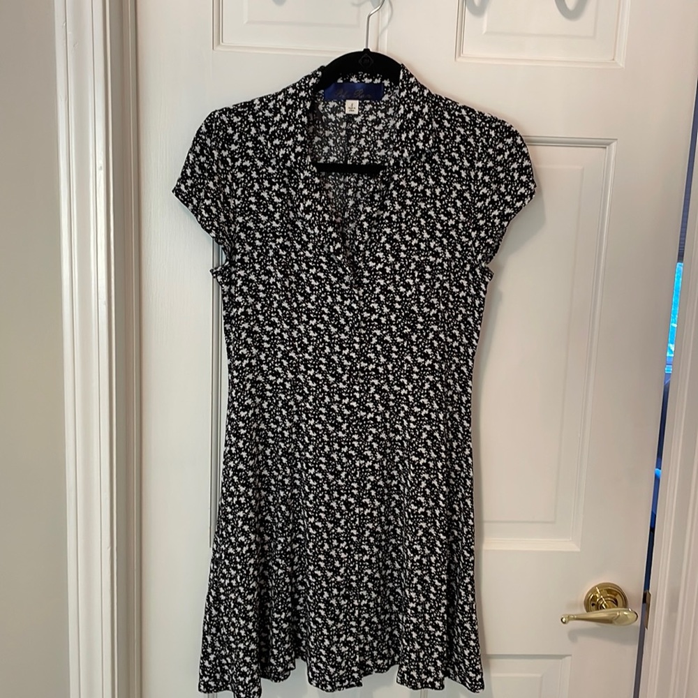 Black and white mid-thigh length dress. Adjustable tie in the back